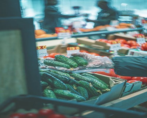 Person shopping for fresh organic produce at market